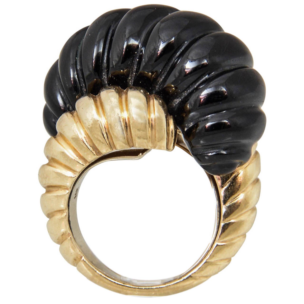 Highly stylized 18k ribbed yellow gold ring with a larger ribbed cut onyx center piece. 
US Size 6 3/4