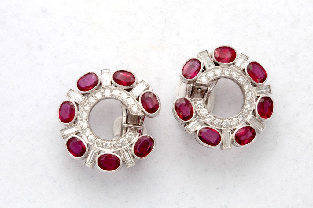 Each C-Shaped Earclip millegrain-set with baguette and brilliant-cut diamonds and oval rubies.