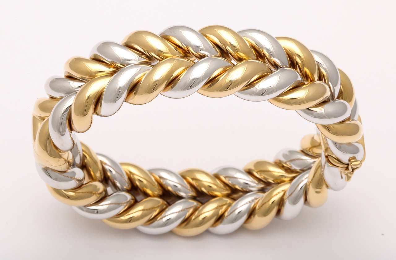 Two color Woven Bangle with Invisible Closing.  Modern - very rich.  18kt White & 18kt Yellow Gold Design