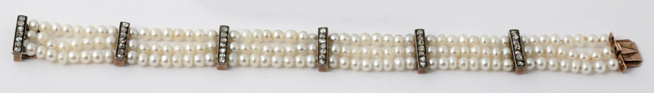 3 Row pearl Bracelet with 5 dividing bars set with single row of old cut Diamonds. Yellow Gold and Silver settings