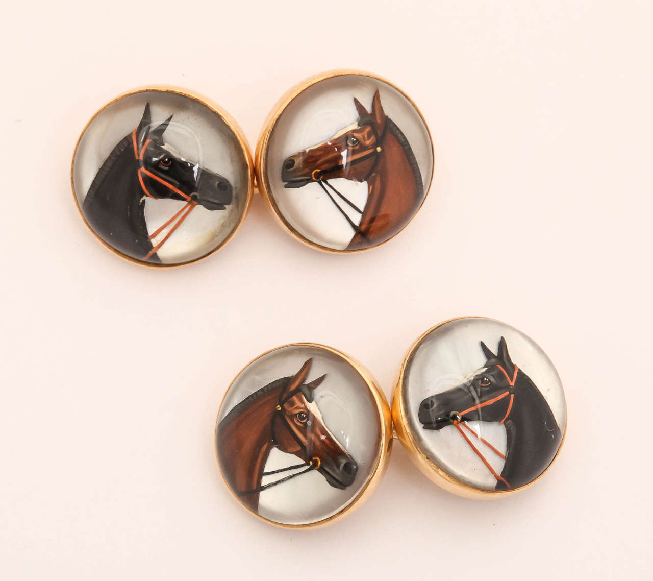 Fabulous pair of 14 carat yellow gold horse Essex, or reverse intaglio cufflinks.

Very beautifully detailed and painted horses.