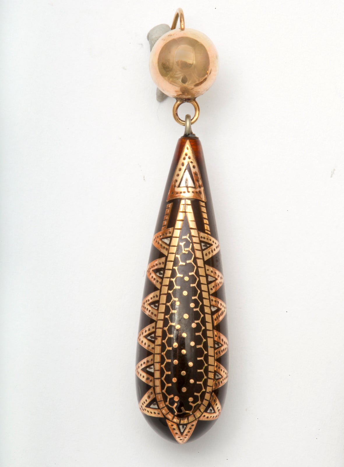 Pique jewelry is an example of an art form of the Victorian age. Tortoise shell was incised with complex patterns and filled with gold and silver. The skill and precision of the work is awe inspiring. In this example of pique work the pattern