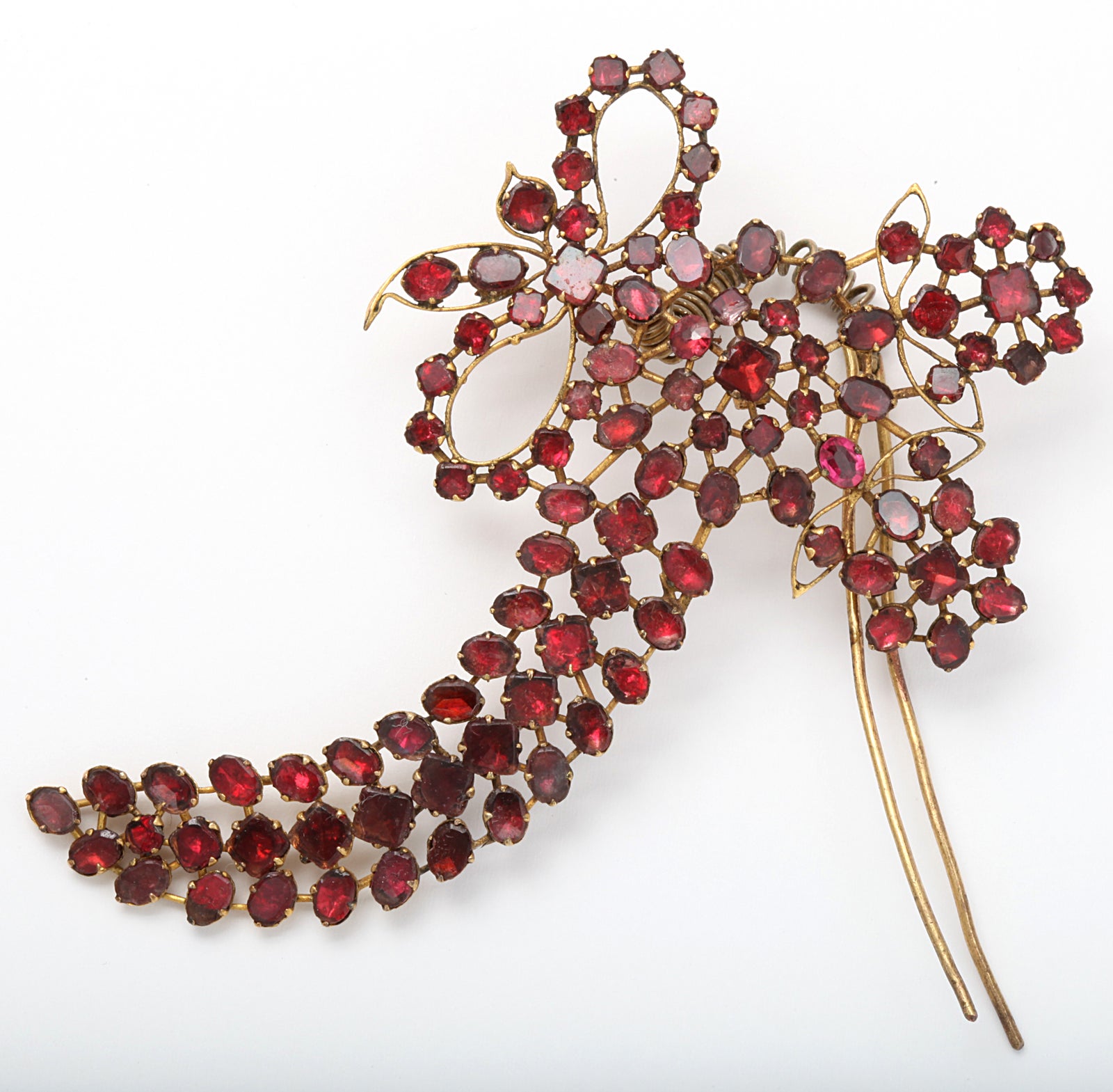 Faceted rose foiled almondine garnets, in a delicious life saver red, form a fancy bow for your hair. The hair comb is attached to a spring so that the aigrette moves or flutters, en tremblant, when worn. Aigrettes were popular in the Georgian era