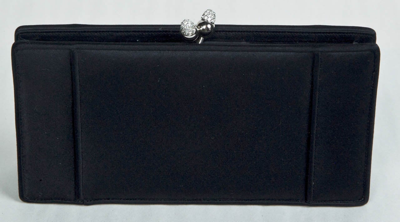 funkyfinders is sharing this minimalist 'black-tie' satin clutch from the house of judith leiber. her rhinestone closure, set in a chrome color fitting, is 'the icing on the cake'. a timeless treasure ready-to-wear with that 'little black dress'.