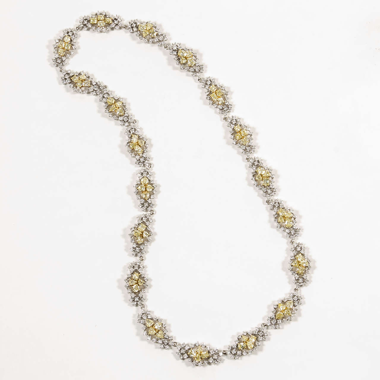 An elegant and timeless design.

5.92 carats of round brilliant white diamonds, 9.42 carats of multishape yellow diamonds set in 18k white and yellow gold.

1.85 carats of round brilliant white diamonds, 3.01 carats of multishape yellow diamonds