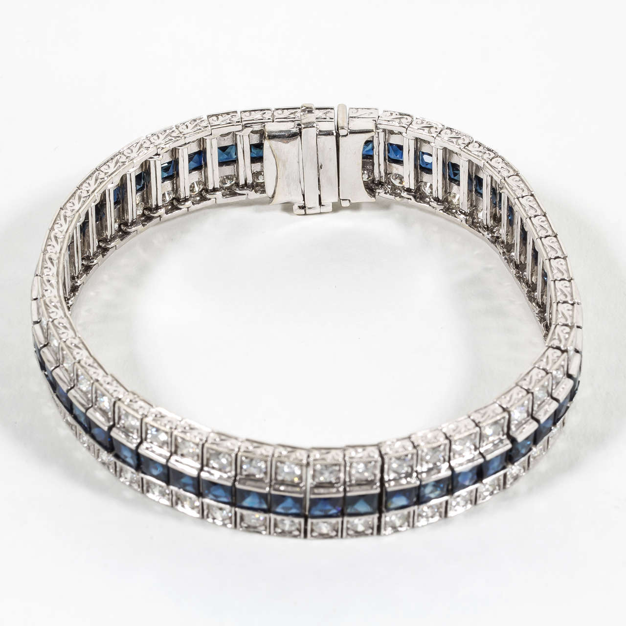 15.80 carats of French Cut blue sapphires!

5.14 carats of round brilliant cut diamonds.

Gorgeous 18k white gold mounting with engraved detailing.