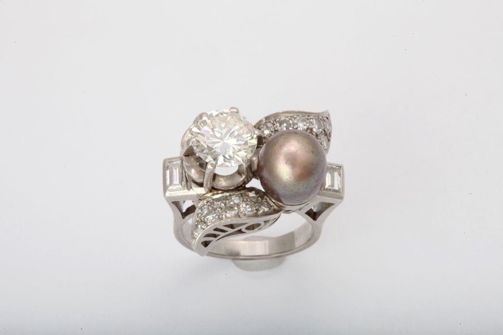 A truly unique natural South Sea pearl and 2 ct  vs G diamond cocktail ring surrounded by diamond baguettes and mine cut diamonds set in a pierced Art Deco platinum form. Appraisal available. Designed with skill Gia certified.