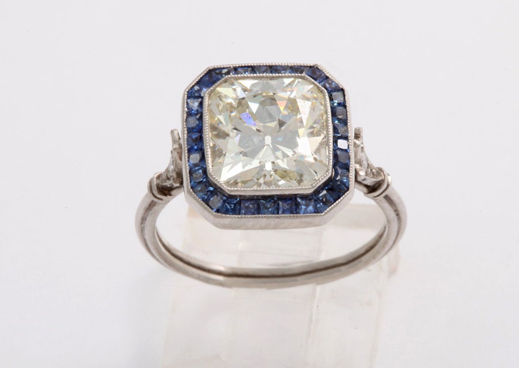 A rare 3.5 cushion cut diamond  engagement ring surrounded by sapphires set in platinum. Excellent quality. Appraisal available.
