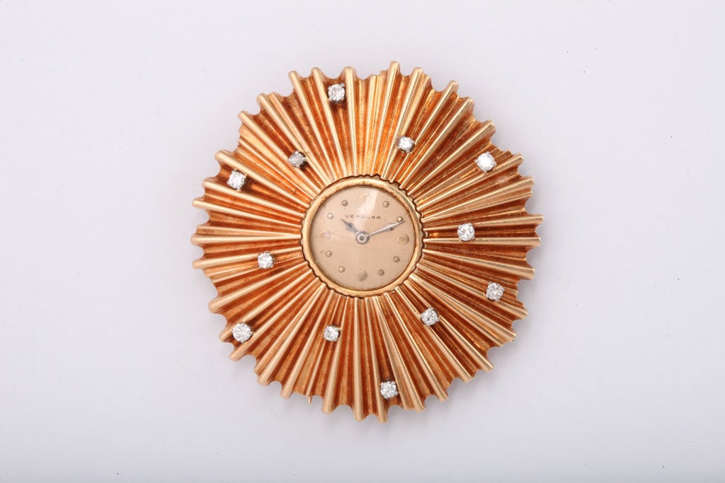 Unique Lapel Watch of Sunburst design.  Sprinkled with Diamonds.  Engraved 