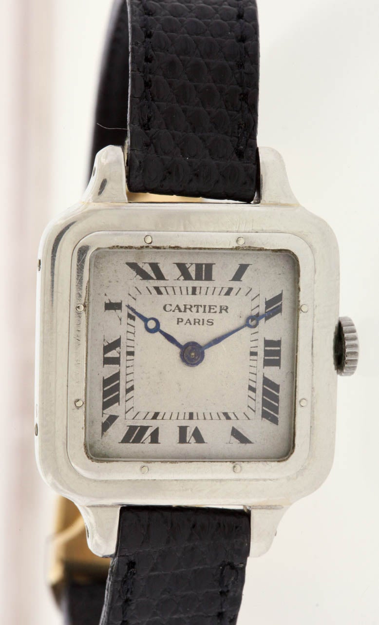 Rare and early 18k white gold Cartier Santos Dumont wristwatch, circa 1910, with an 18K pink gold Cartier deployant buckle. The 25mm x 25mm case has 4 screws on the case band, case back engraved: 