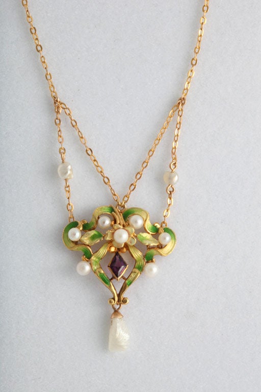 Art Nouvea enamel pendant featuring amethyst and natural fresh water pearls designed in a garland style. The pendant is 10k and the chain is 14k yellow gold.