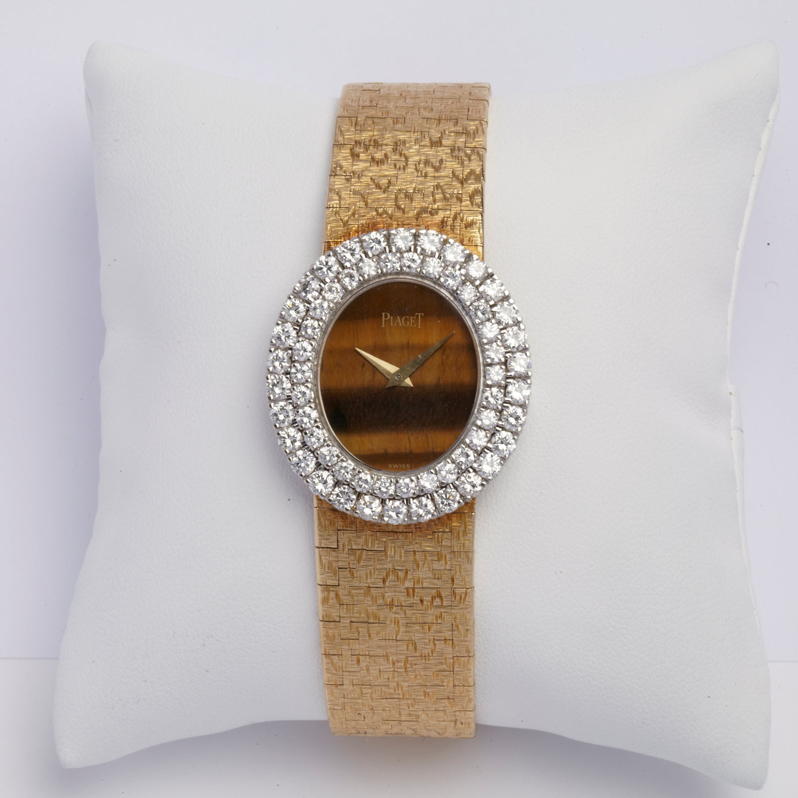 A diamond and yellow gold Piaget watch with tiger's eye dial, circa 1960.