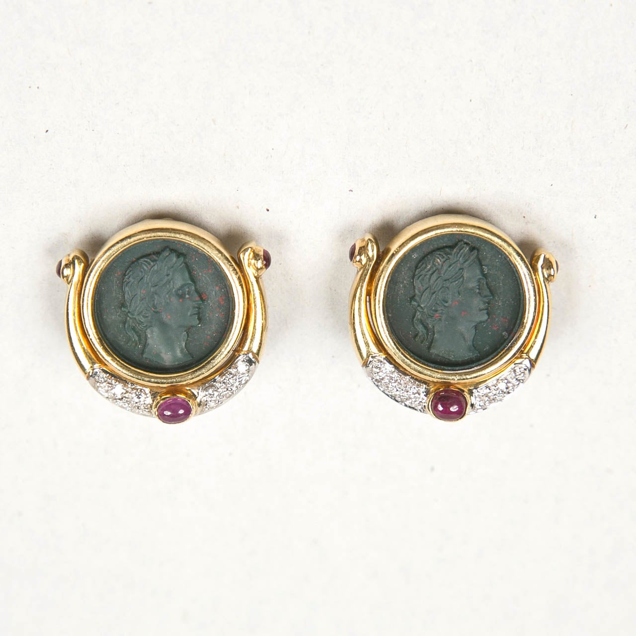 Ancient Roman Italian coin clip earrings set in gold with pave diamond and cabochon rubies.