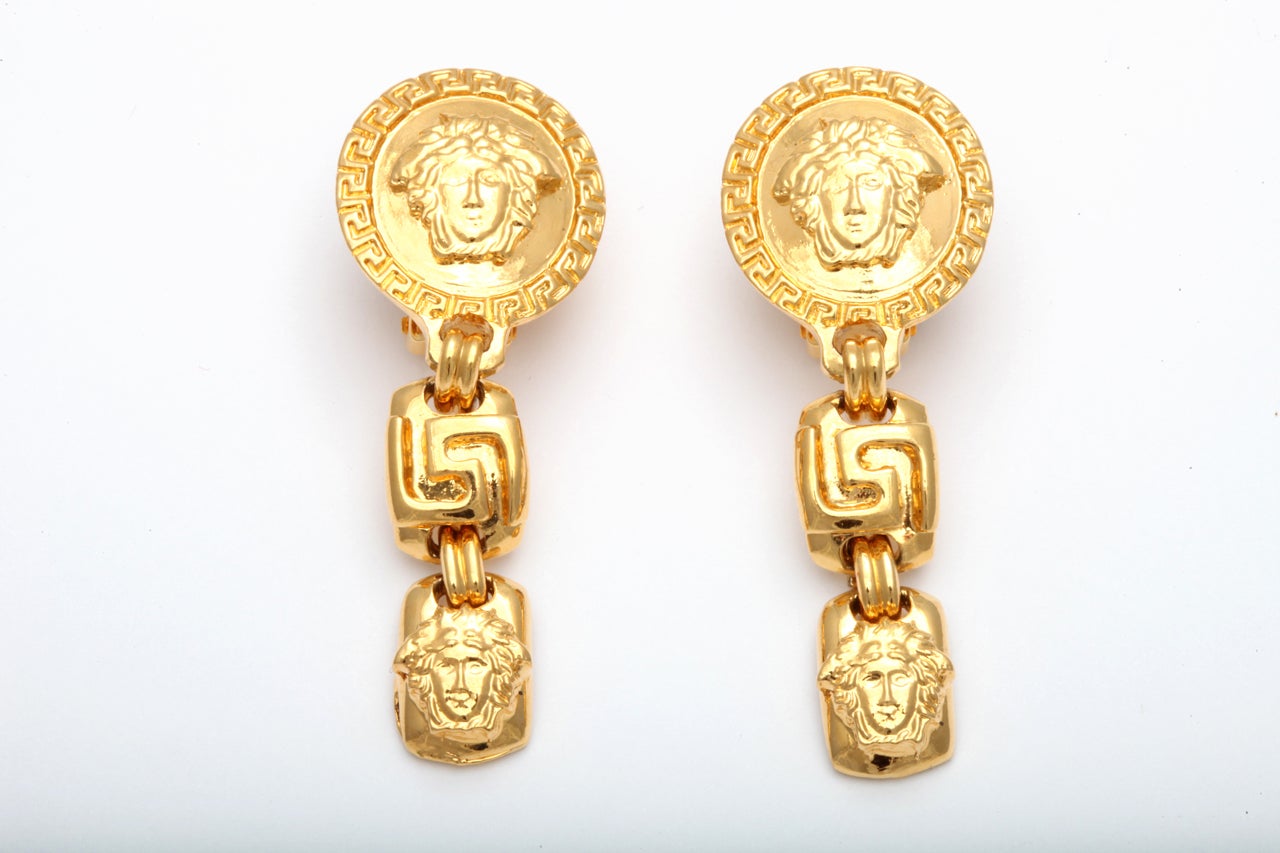 Rare Gianni Versace dangling earrings with Medusa and Greca motifs.