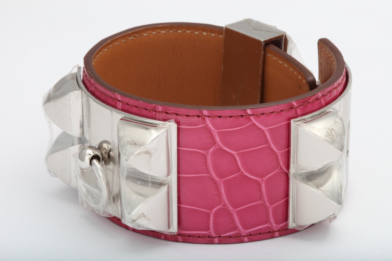 Extremely rare Hermes Collier de Chien bracelet with fusha alligator leather and silver hardware.
Size S (Women's).