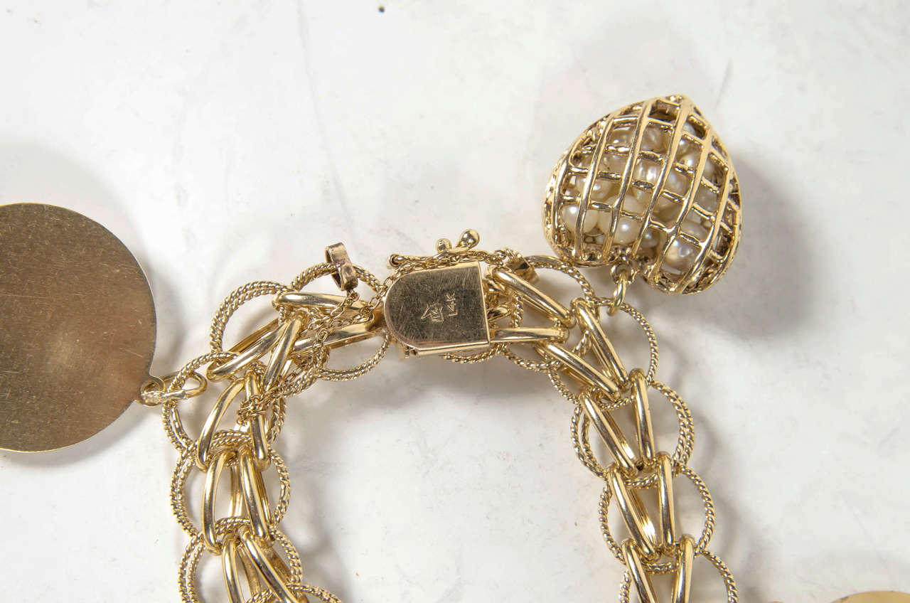 1950s Gold Multi Charm Bracelet With Cartier Charm In Excellent Condition In New York, NY