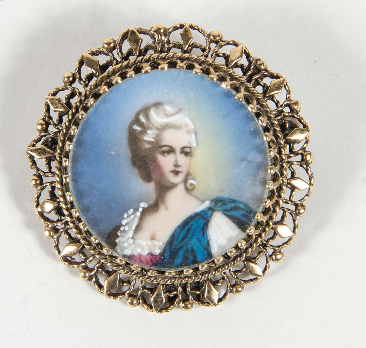 This very elegant brooch features a hand painted portrait fitted in a 14k yellow gold  Renaissance revival surround. It is marked 14k as well.