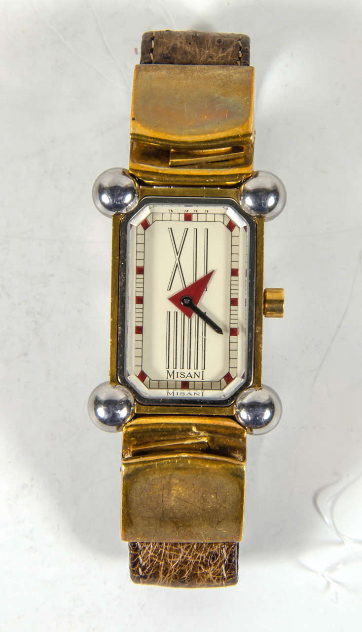 A lady's stainless steel and gold and diamond set wristwatch. A 1980's Quartz movement, cream dial with Roman numerals at 12 and 6, geometric hands, rectangular case with 2 diamonds set at the clasp and the crown , back held by 4 screws, fitted