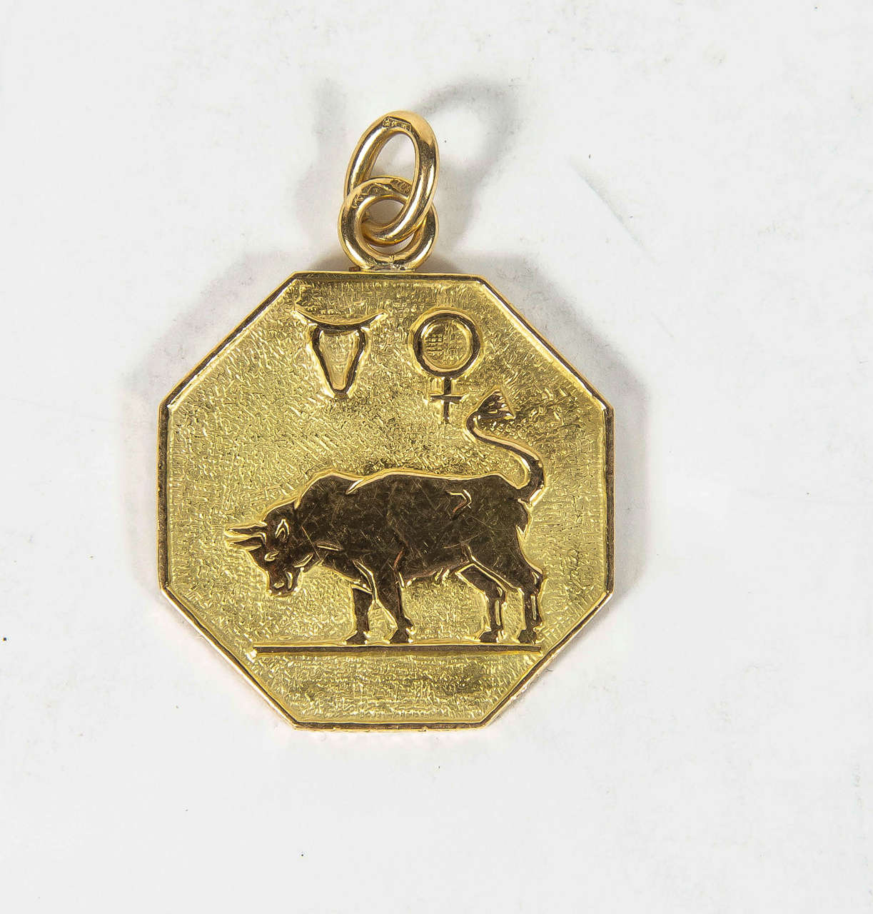 This pendant/charm is 18k yellow gold a depicts a relief bull with elements of the Taurus zodiac. It is signed Buccelatti as well.