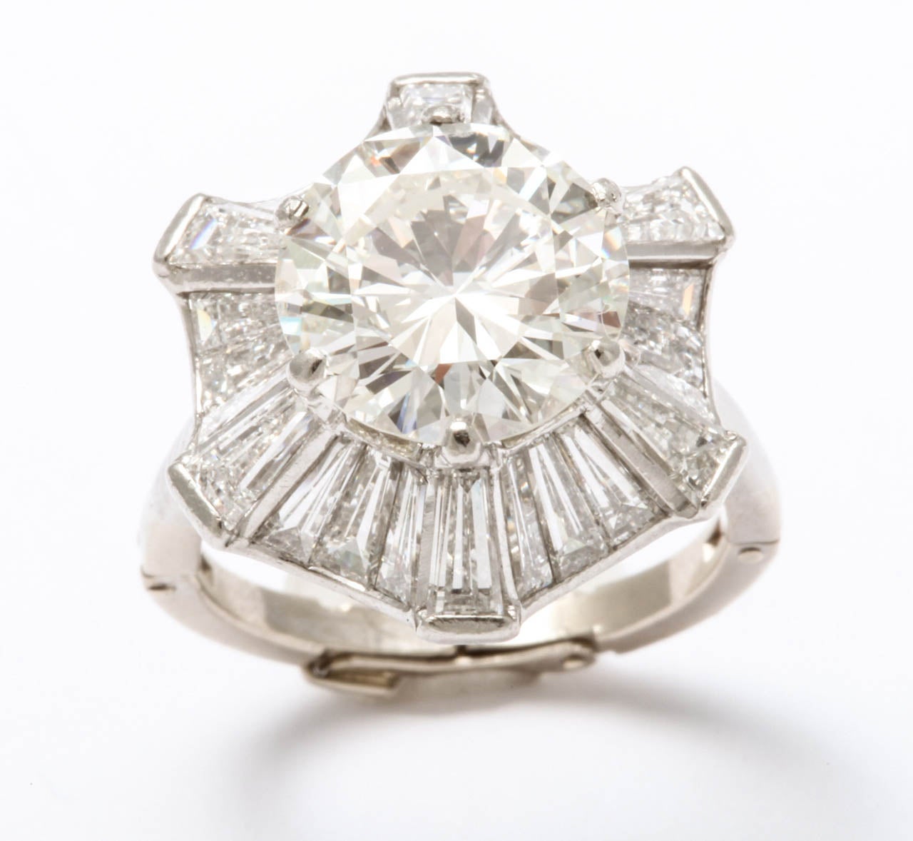 The ring consisting of a round brilliant-cut diamond, weighing 5.00 carats, within an undulating baguette-cut diamond surround; remaining diamonds weighing approximately: 2.45 carats; size 8 (with adjustable mount). Accompanied by GIA report