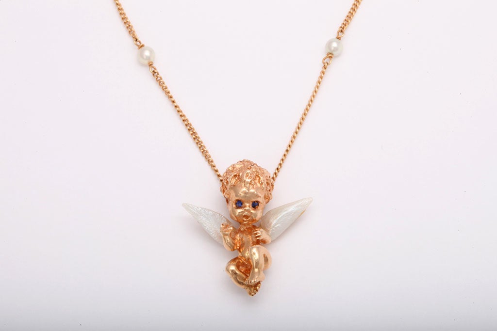 This delightful Ruser child is an angel with fresh water pearl wings.  The chain has 8 small cultured pearls.  It is only 14.25