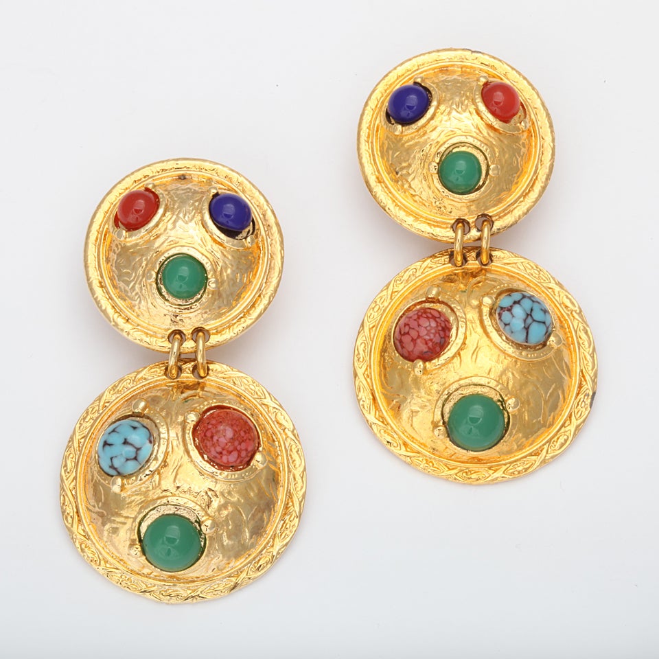 Large gold tone double shield form dangle earrings with multi colored cabochons.
