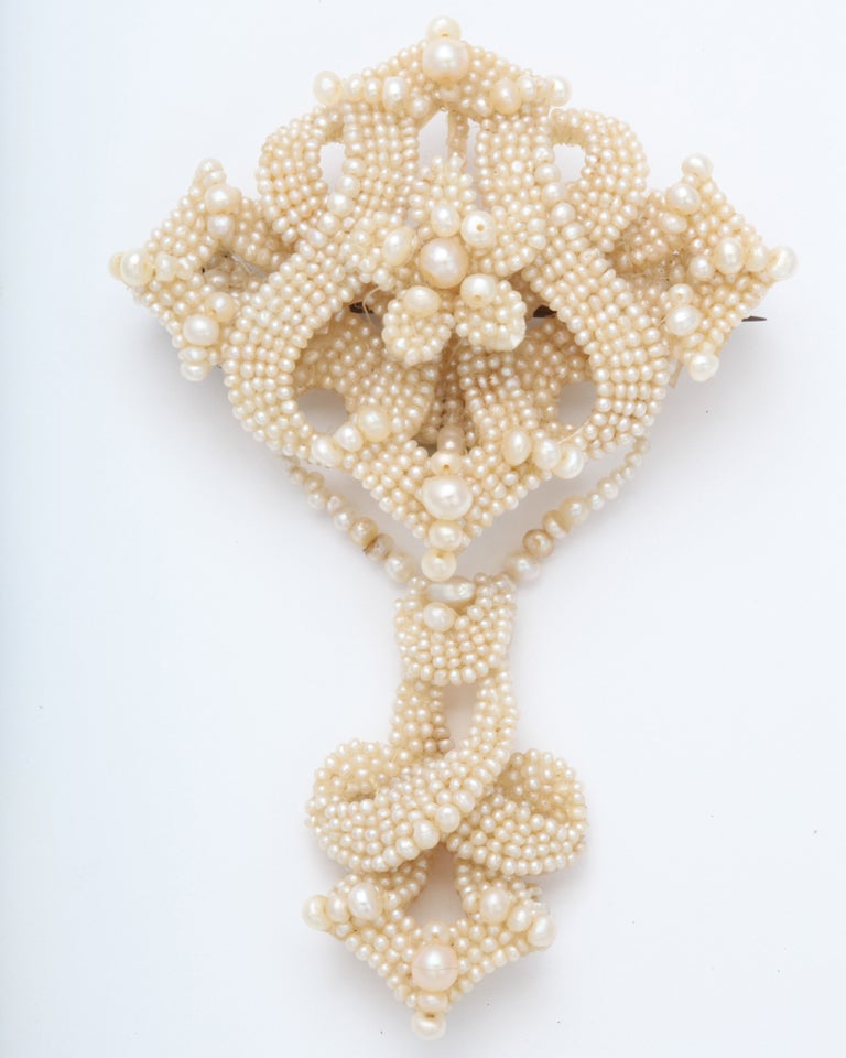 From my personal collection this is, no doubt,  one of the most wondrous examples of woven seed pearl jewelry. The design incorporates flowers, flourish, a bow, a knot and a lyre form in the center of the upper section. Symbolizing innocence, seed