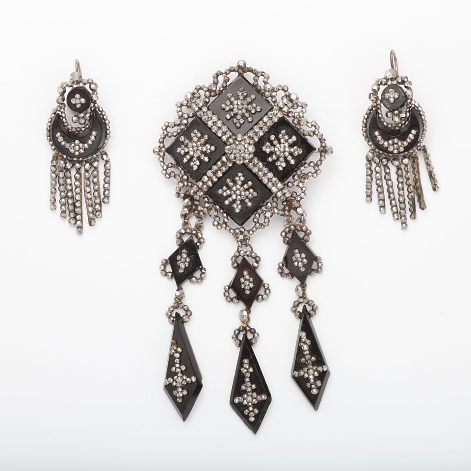 For the Georgian Jewelry Collector or the woman who loves unique period movie drama, a Cut Steel Pendant/Brooch of Tiny faceted hand cut steel bits set in Vauxhall Glass, also known as French Jet. The tiny multi sized cut steel pieces have the
