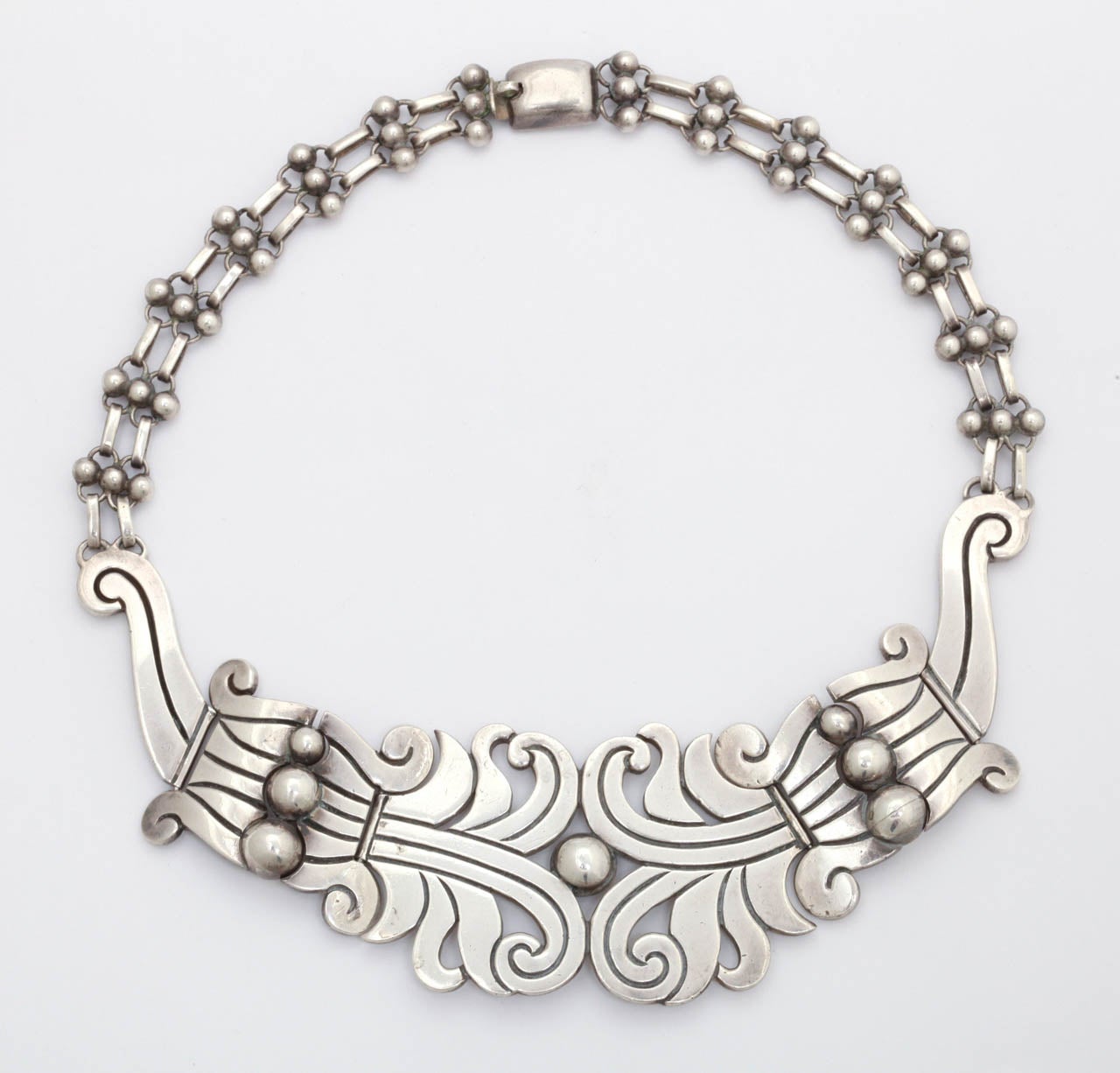 A necklace of forceful presence by master silversmith Hector Aguilar, one of the famous and finest Mexican jewelry designers of the 1940's. Aguilar is a success story. He was made manager of William Spratling's original shop Taller de Delicias in