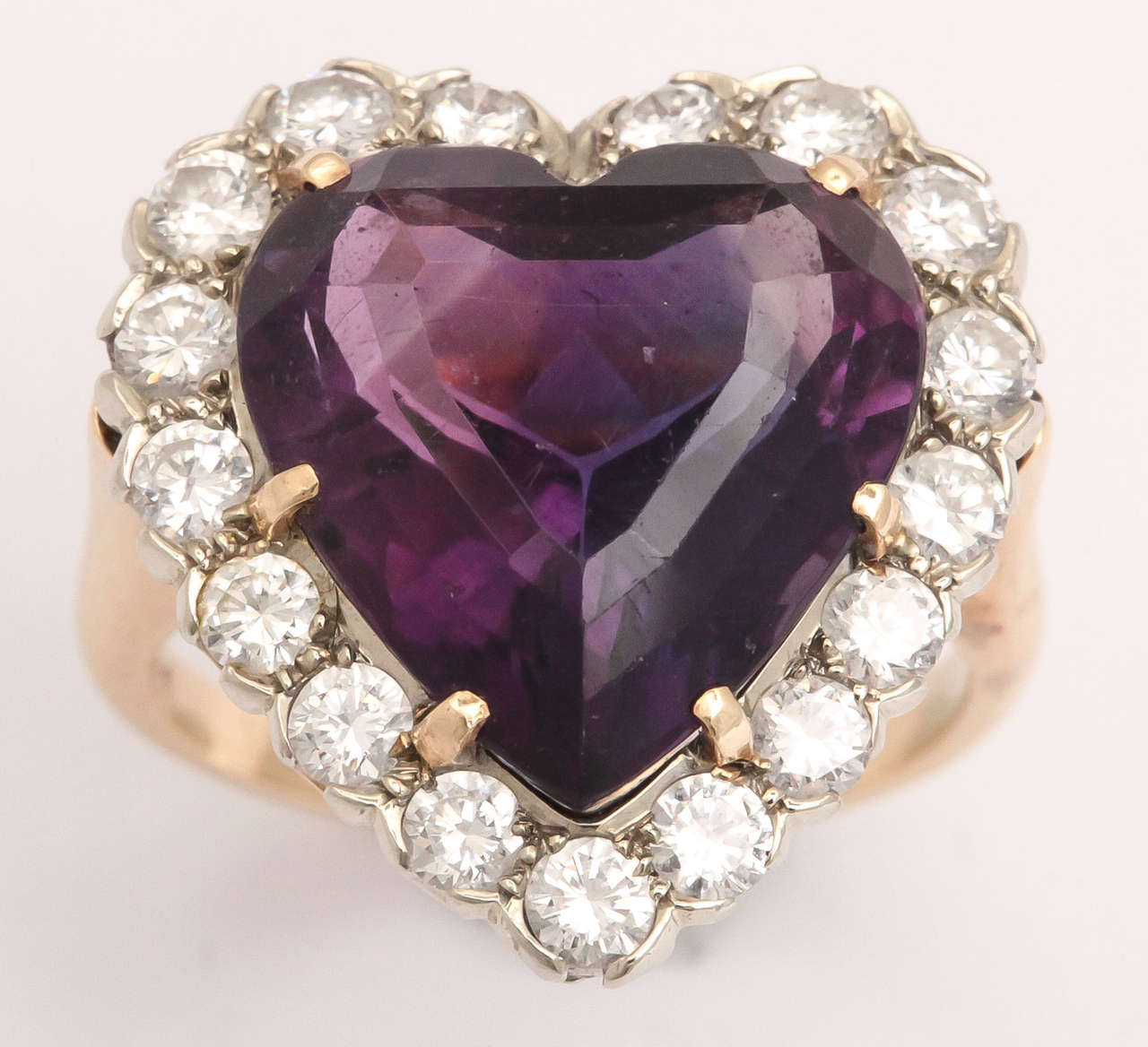Attractive intense Amethyst prong set in 14kt Yellow Gold & surrounded by full cut clean & White Diamonds bezel set  in White Gold.  So reminiscent of that 50's look