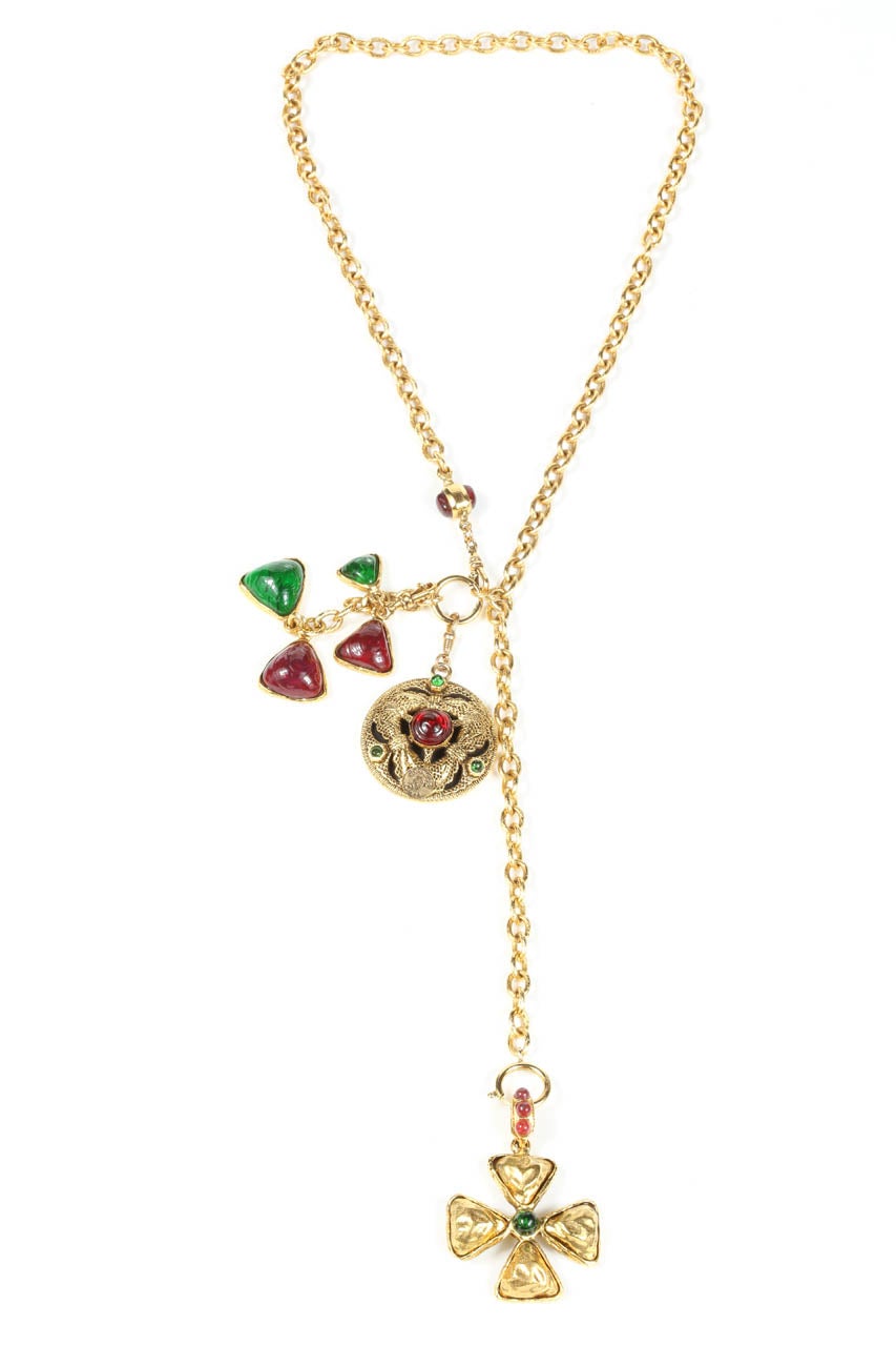 A chic lariat necklace with clip on charms set with poured glass in deep red and emerald green. The round charm, which measures 1.75
