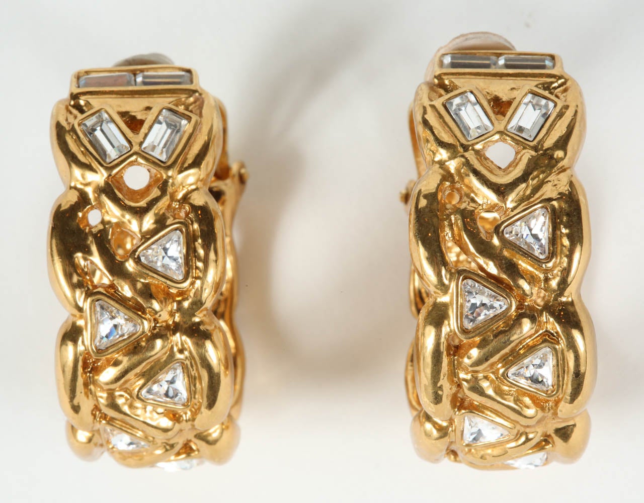 A sparkly pair of gilt metal hoop ear clips by Yves Saint Laurent set with faceted rectangular & triangular rhinestones. Stamped YSL on the back of the clip (see Image 7).