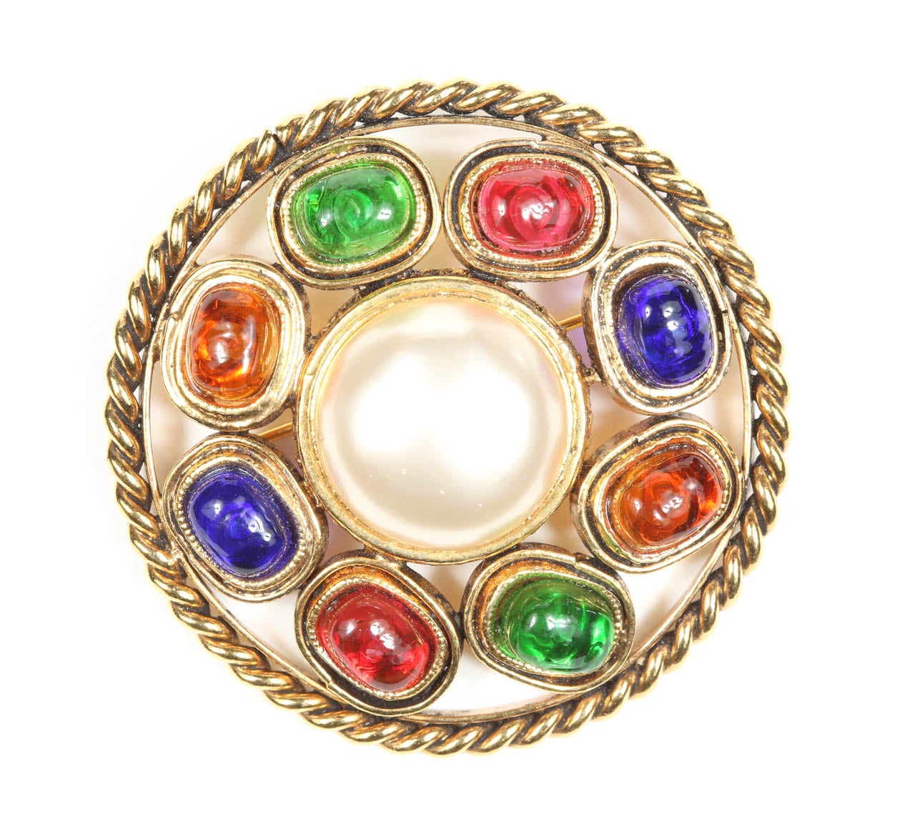 A colorful Chanel brooch with a ring of colorful poured glass cabochons around a central glass pearl and framed in a gilt metal rope. Marked on the back with the 