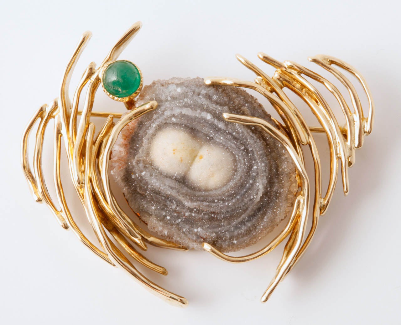 A gold, emerald and agate brooch by Anneke Schat. Designed as a free form centrally set with agate matrix, flanked by yellow gold curved bars and a cabochon emerald . Engraved Anneke Schat.

All of our prices exclude VAT.