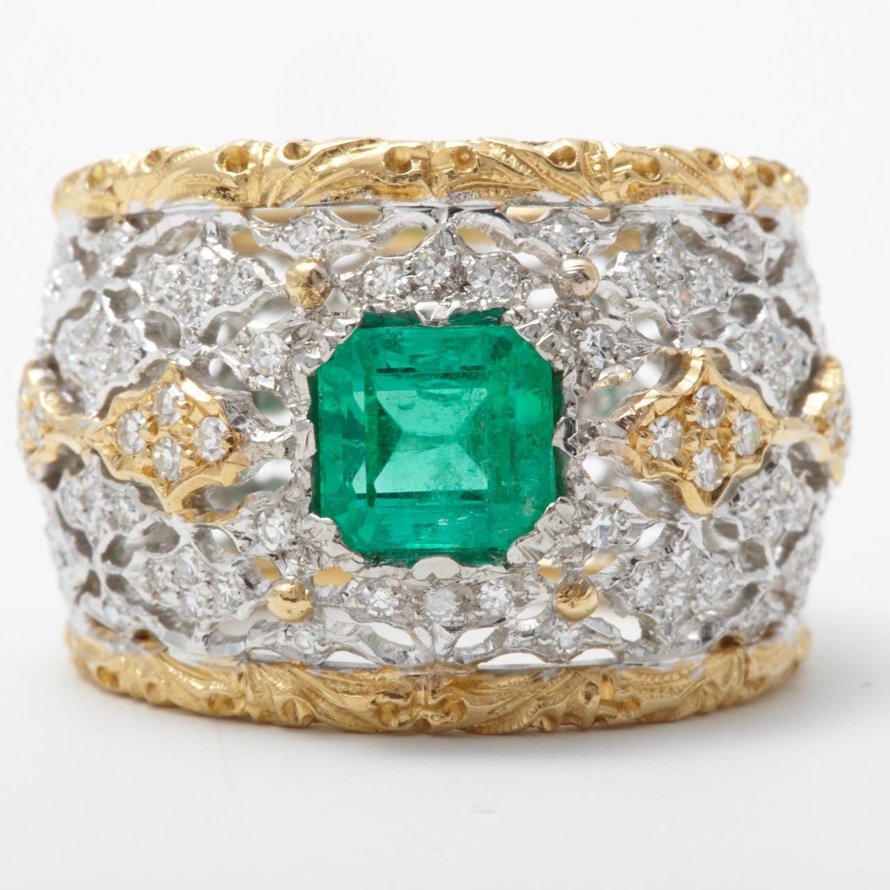 A gold, emerald and diamond dress ring, Buccellati
The cut-cornered emerald weighing  1.34 ct to a 18K white and yellow gold pierced band decorated with brilliant-cut diamonds.  Engraved Federico Buccellati.  Ring size 6 1/4 - 16 3/4.

All of our