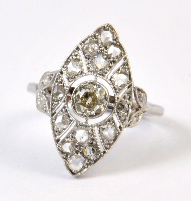 A platinum Marquise Art Deco ring set with a 0,40 ct central diamond enhanced with approx. 1 ct of rose cut diamonds.