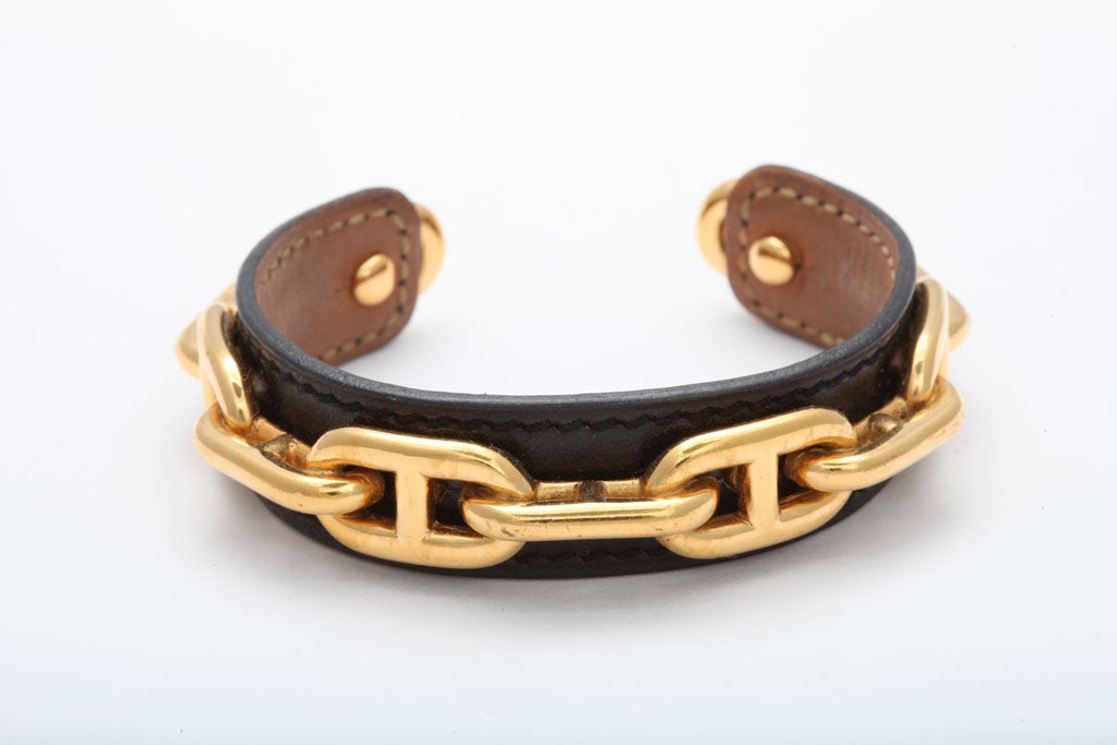 Very rare Hermes black leather bangle with gold chain motif.
7.2 inches around, hight 0.65 inches, opening 1 inch.