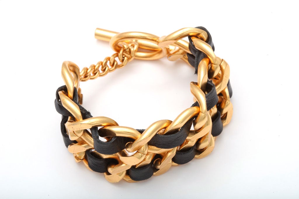 Chanel double chain bracelet in signature black and gold.