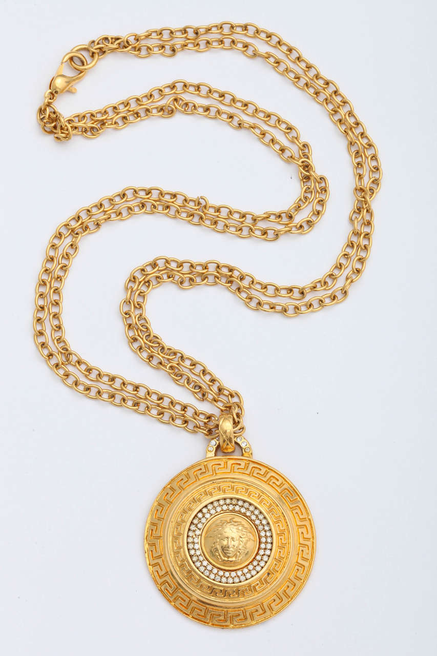 Very rare Gianni Versace large medallion pendant with iconic Medusa and greca motifs.