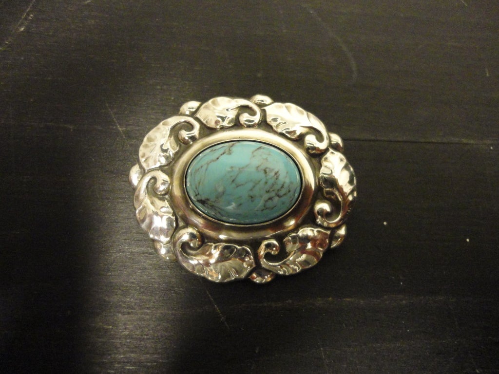Vintage sterling silver Art Nouveau brooch #60 with turquoise designed by Georg Jensen.
Measures 1 5/8