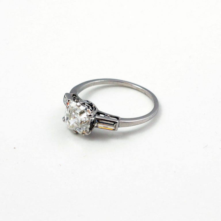 Asscher cut diamond ring, mounted in platinum. Having baguette cut diamond shoulders. Diamond weighs 2.11ct , E SI1.