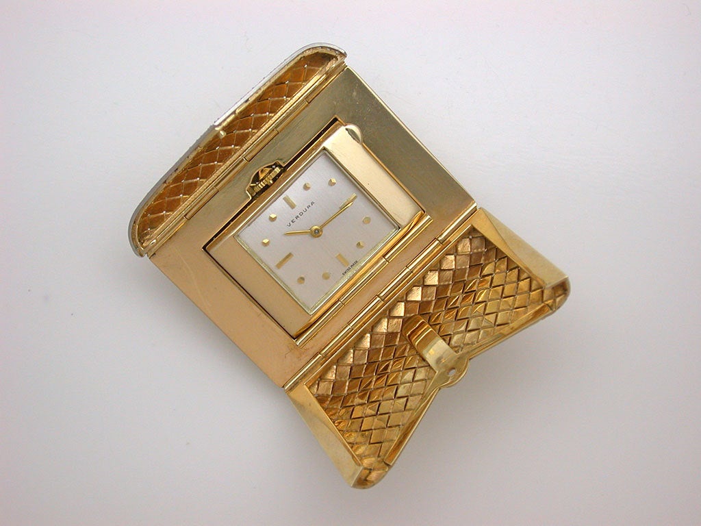 The hinged envelope of basket weave design opening to reveal a polished interior with rectangular watch face on a swivel, dial signed VERDURA, gold markers and hands, stamped 14k, with maker's mark for Louis Tamis, ca. 1950. In good working order.