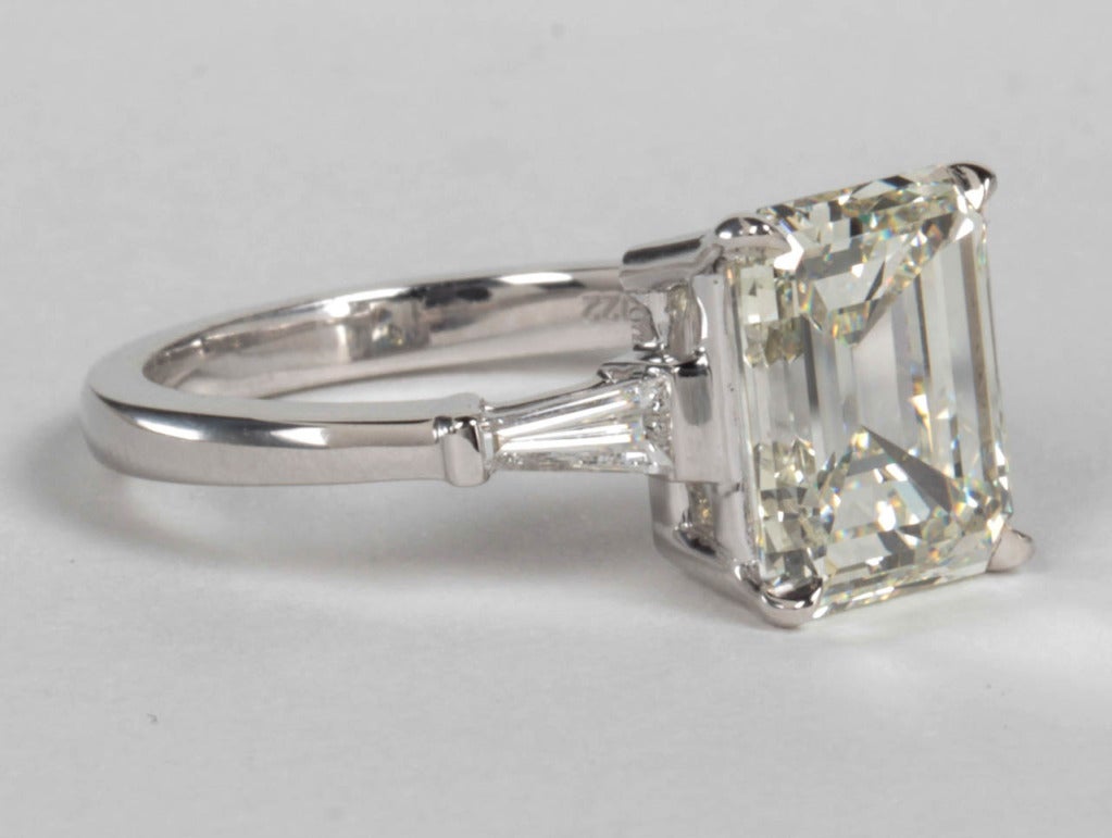 Beautiful 4.09 carat emerald cut diamond certified by GIA. 

The center diamond is K in color and VS1 clarity.

This beautiful diamond is set in a 18k white gold setting with .22 carats of matching tapered baguette cut diamonds.

Please feel