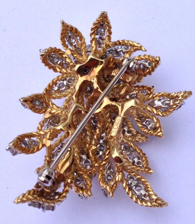 A fine and rare Kurt Wayne diamond en tremblant brooch. A exquisitely hand constructed 18k yellow gold foliate with a trembling diamond cluster top (approx. 7ctw ). Signed item, model #3043 .