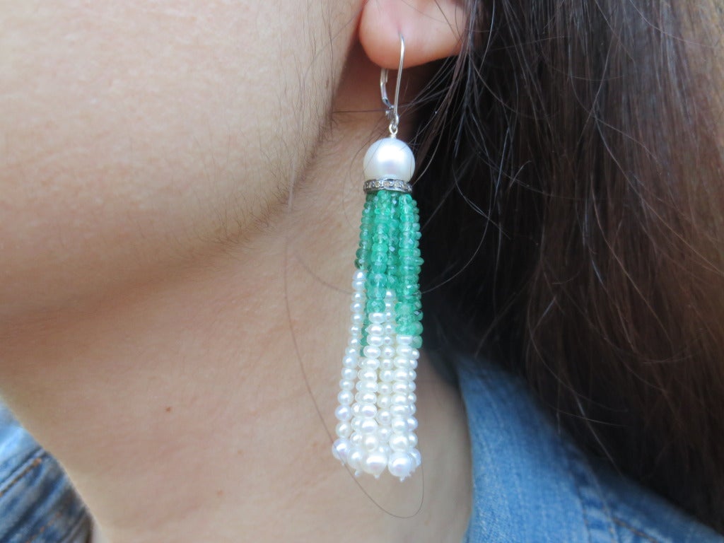 These timeless earrings feature a large pearl drop cup set on a sterling silver and diamond rondelle. The tassels are made of faceted emerald beads and graduated pearls. Ear wire is 14k white gold. Earrings measure 3 inches from top of ear wire.