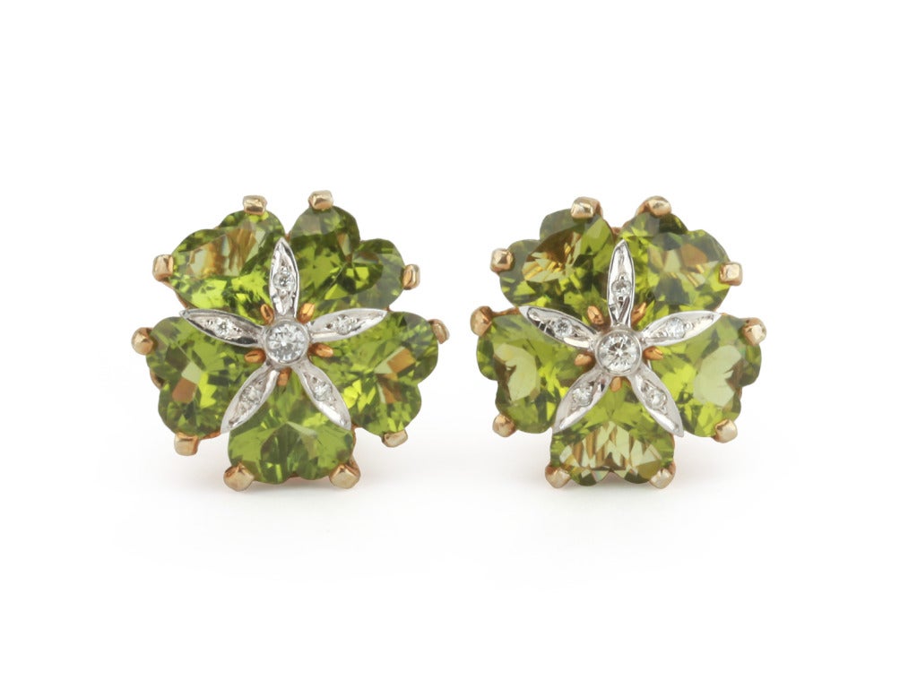 18kt yellow gold sand dollar earrings with peridot (approximately 20 cts) and diamonds weighing 0.30 cts.

Specifications: 7/8" diameter
Omega clip back.
Can be posted for pierced ears.
Other stone options available.