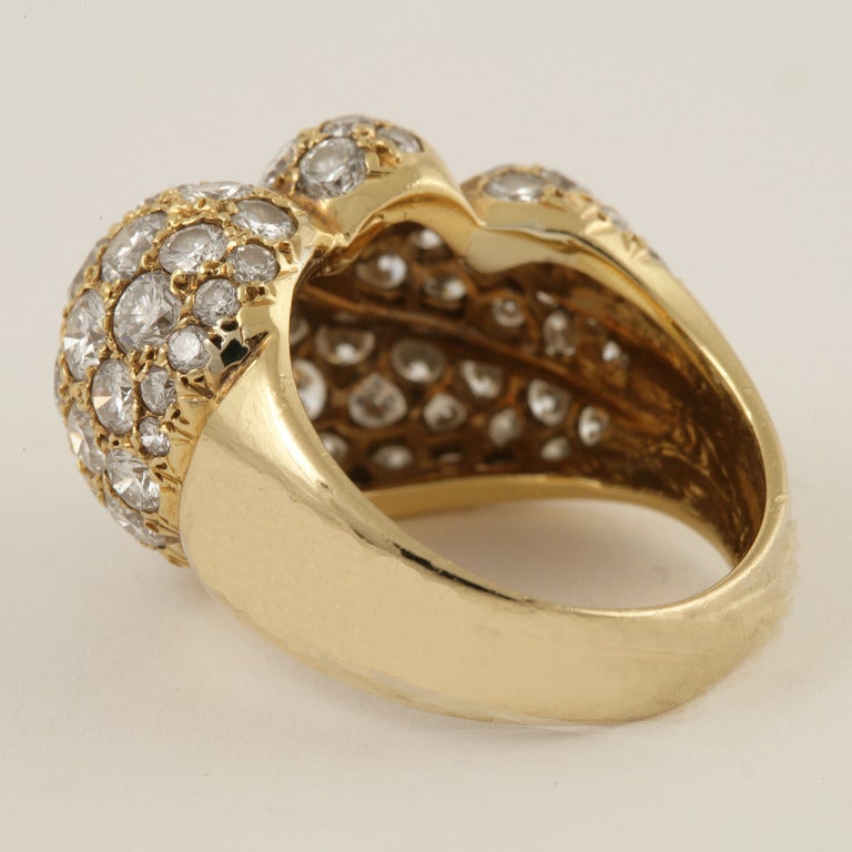 A Mid-20th Century 18kt gold and diamond ring. The ring is a swirl of 86 round-cut pave diamonds, approximately 4.35 carats total weight.The diamonds have a VS clarity range and a G-H color grade.  In a swirl motif.  This ring can be sized.