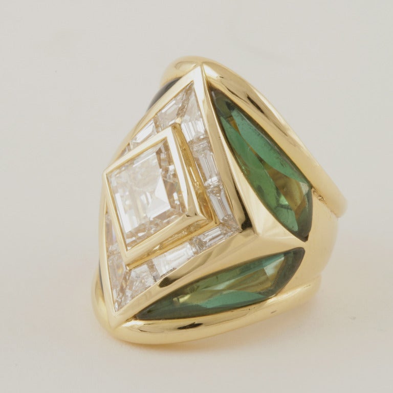 A French Estate 18 karat gold ring with diamonds and tourmalines by Marina B. The ring has 12 baguette-cut diamonds with an approximate total weight of 2.44 carats, a center square-cut diamond with an approximate total weight of 4.19 carats, and 4