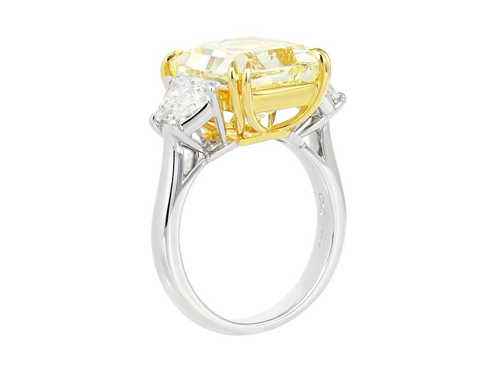 Platinum and 18 karat yellow gold custom made 3 stone ring consisting of 1 radiant cut natural canary diamond weighing 9.37 carats having a color and clarity of FY/SI1, measuring 13.05 x 10.52 x 7.29mm with GIA certificate #5151209024 and flanked by