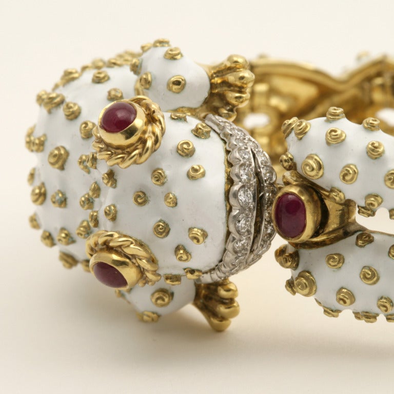 An American Mid-20th Century 18-karat gold and platinum bracelet with rubies and diamonds by David Webb. The bracelet has 4 cabochon rubies with an approximate total weight of 2.80 carats, and 22 round-cut diamonds with an ATW of .50 carat. The head